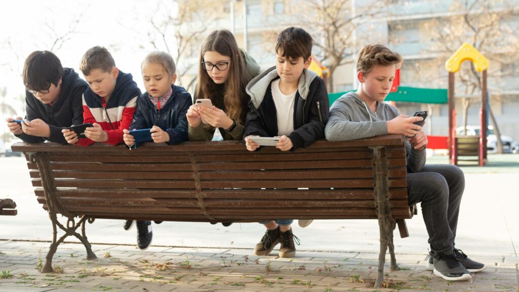 Children addicted in their phones outdoors